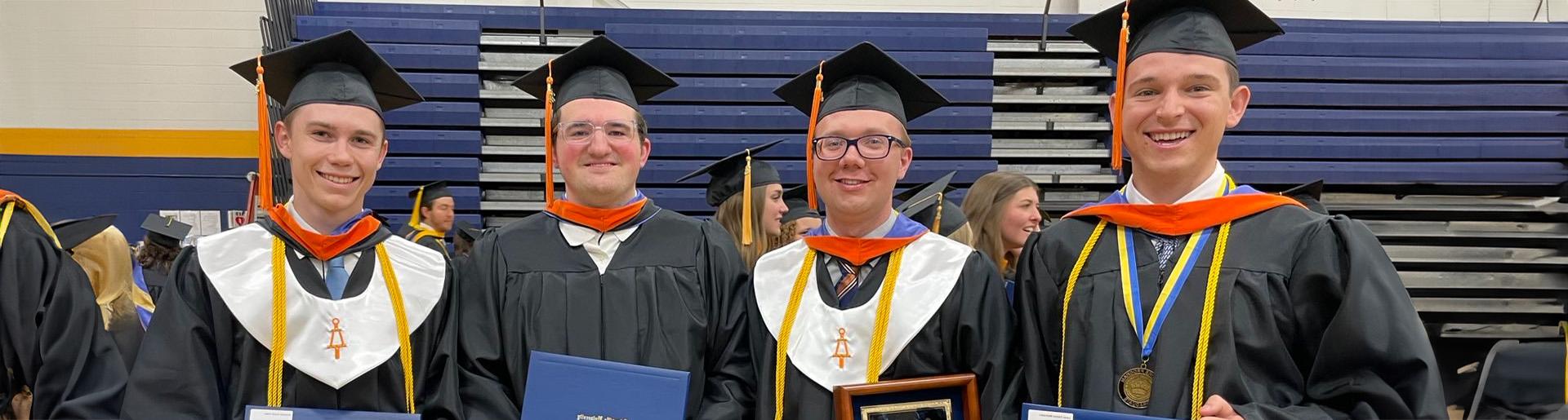 Leadership team for Midian Prime – from left to right: Lucas Mattocks, Willem Vandermeij, Matthew Brugel, Krestian Robe in cap and gown as they celebrate graduating from Cedarville University